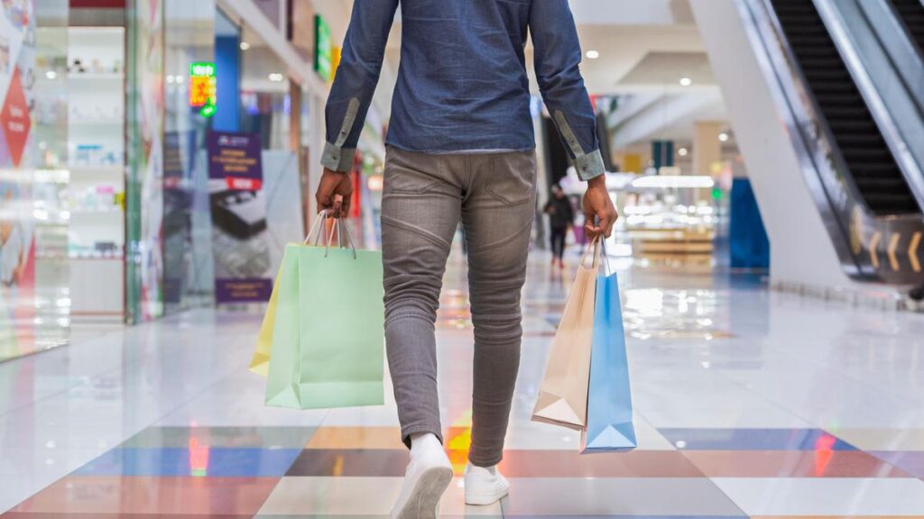 African american man walking with shopping bags