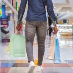 African american man walking with shopping bags