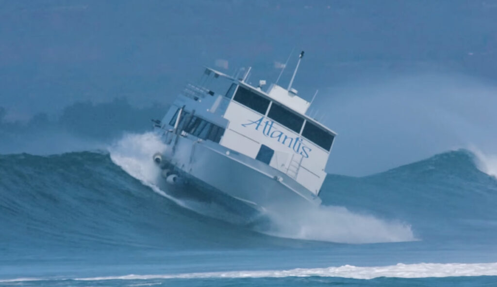 jamie-o-brien-chronicles-historic-boat-floater-amid-high-surf-in-honolulu