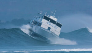 jamie-o-brien-chronicles-historic-boat-floater-amid-high-surf-in-honolulu