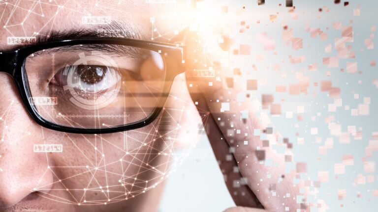 The abstract image of the businessman wear a smart glasses overlay with futuristic hologram. The concept of modern life, technology, iris scanner and internet of things