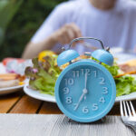 Alarm clock with IF (Intermittent Fasting) 16 and 8 diet rule and weight loss concept.-Diet plan concept