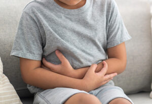 Portrait,Of,Sick,Unhappy,Little,Child,Asian,Boy,Touching,Belly