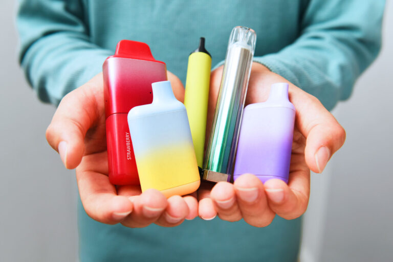 Schoolboy holding vapes in school