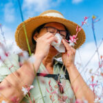 Mature woman has an allergic reaction to flowers pollen