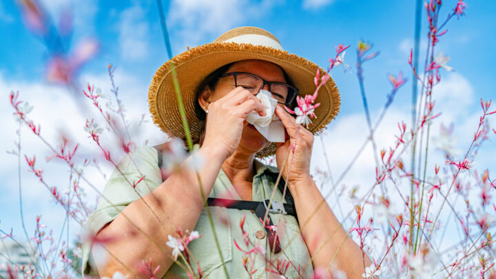 Mature woman has an allergic reaction to flowers pollen