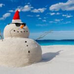 Christmas Sandy Snowman on a beautiful sand beach - Christmas symbol of countries where the weather is always warm