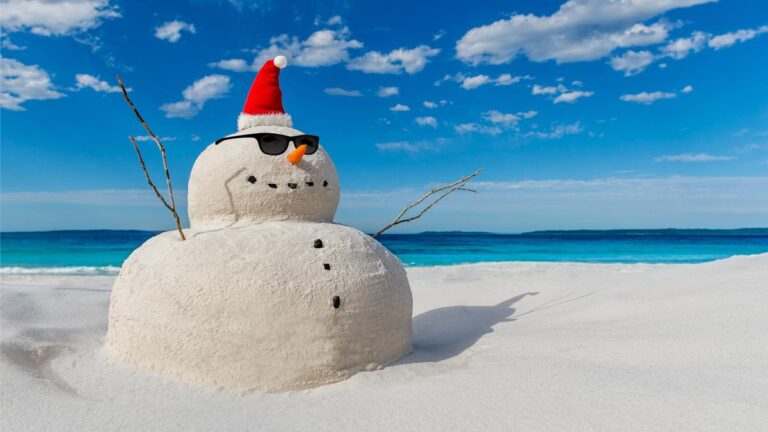 Christmas Sandy Snowman on a beautiful sand beach - Christmas symbol of countries where the weather is always warm