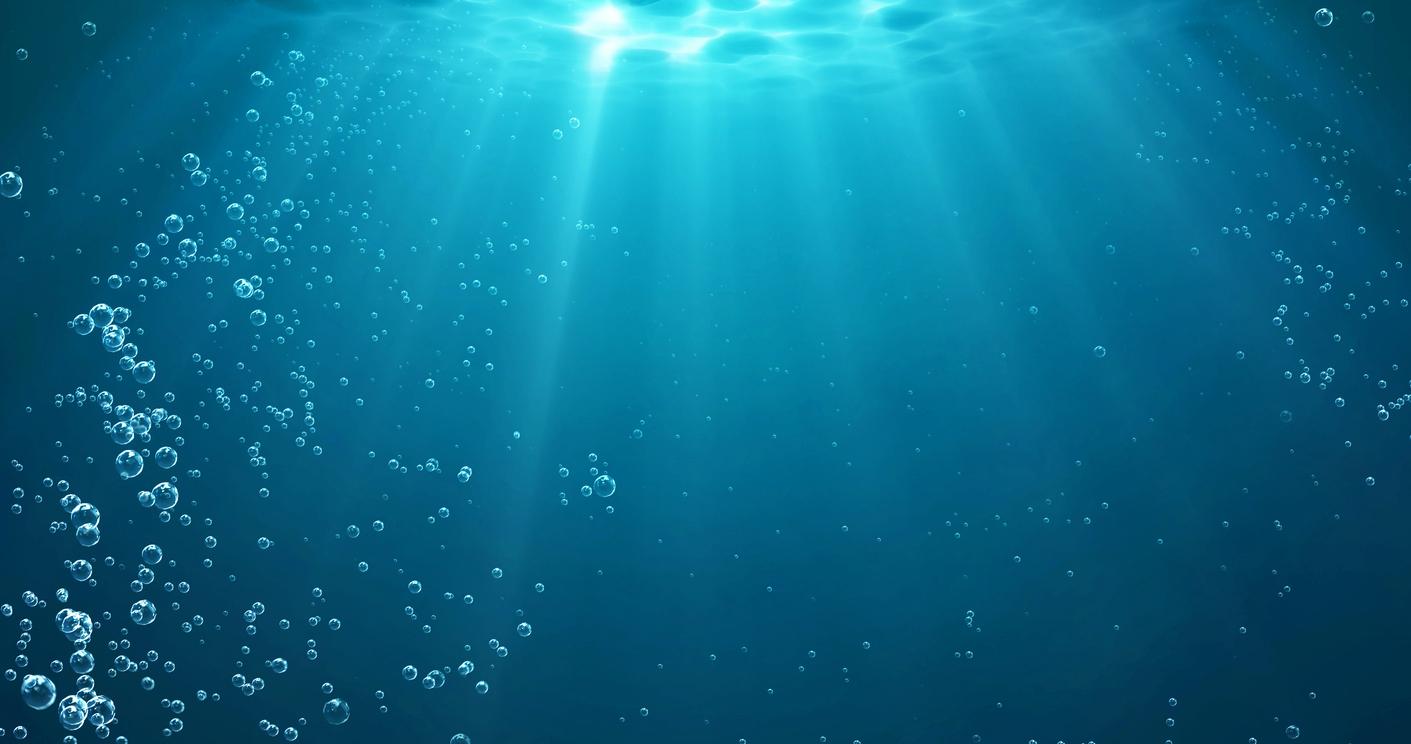 Underwater background with water bubbles and undersea light rays shine