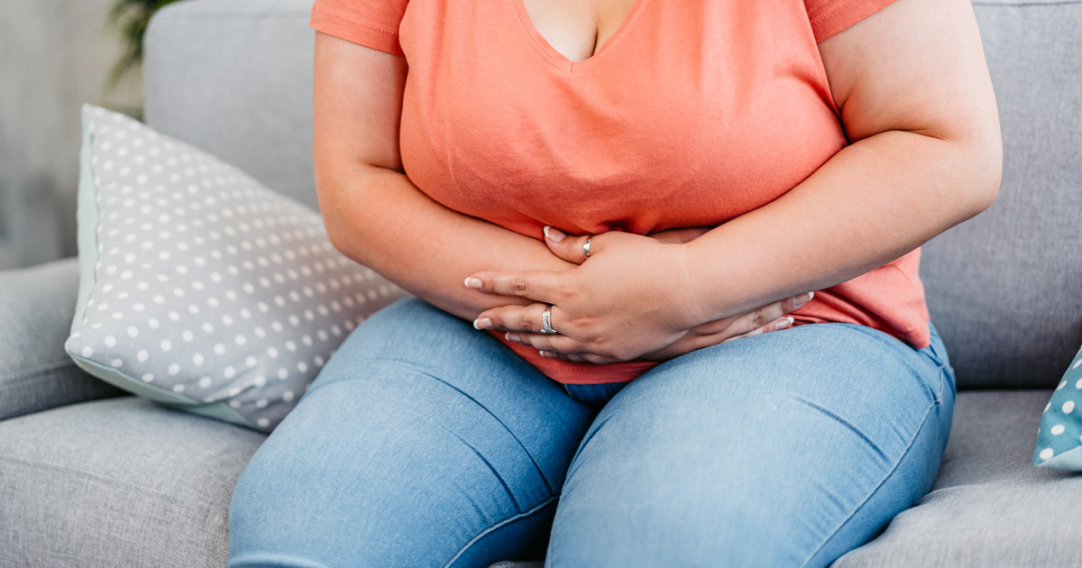 Young Woman Having Stomachache At Home